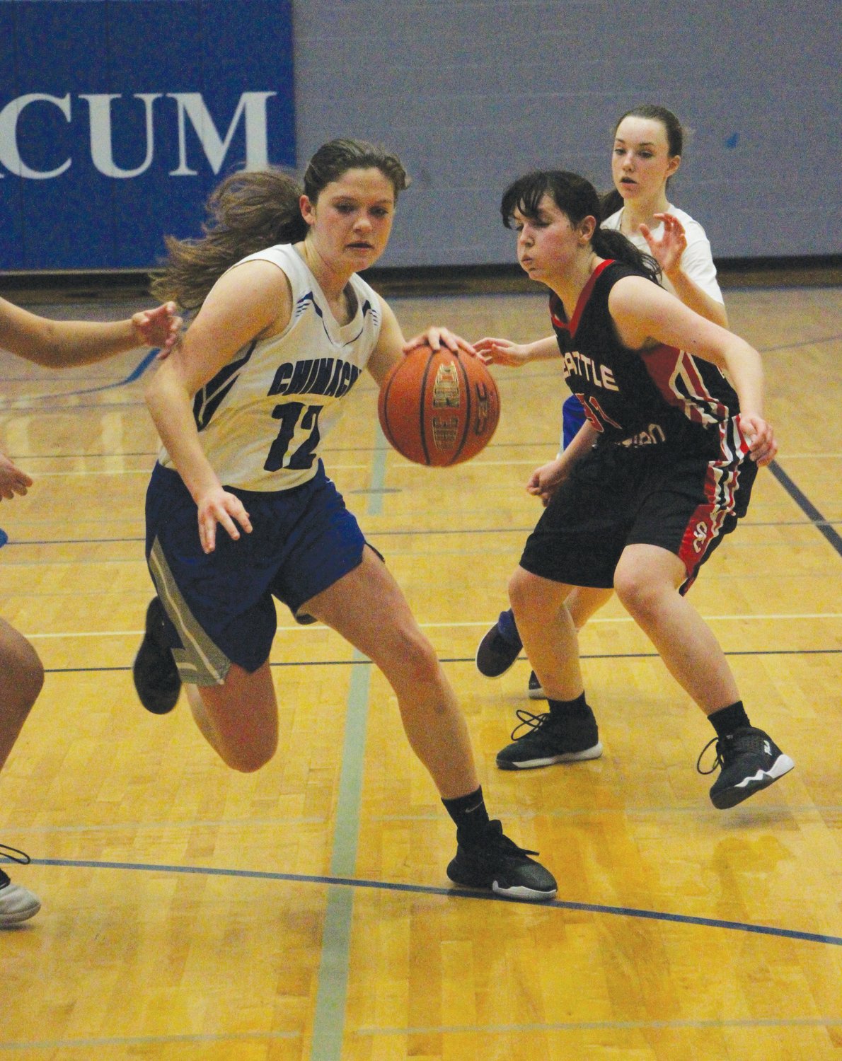 Rivals starter Aurin Asbell weaves between defenders on her way to the bucket.